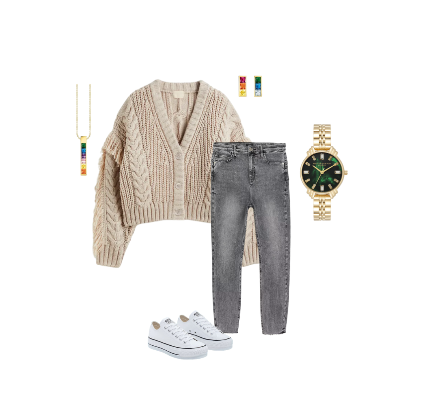 Rainbow gold tone Thomas Sabo necklace and earrings, with gold and emerald green Olivia Burton watch pictured with a beige chunky knit jumper with grey skinny jeans and white converse outfit.