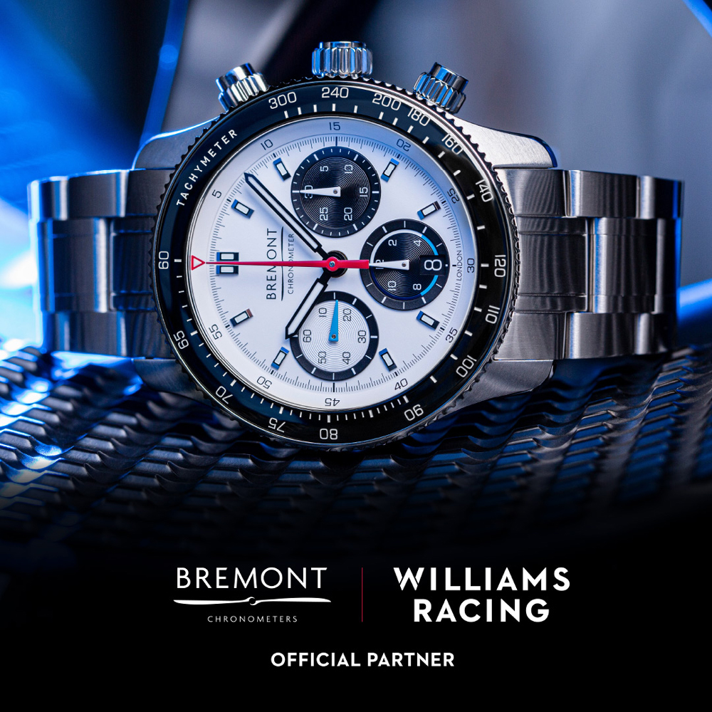 Bremont Williams WR-22 Sports Chrono watch with white dial and bracelet laid on a tyre